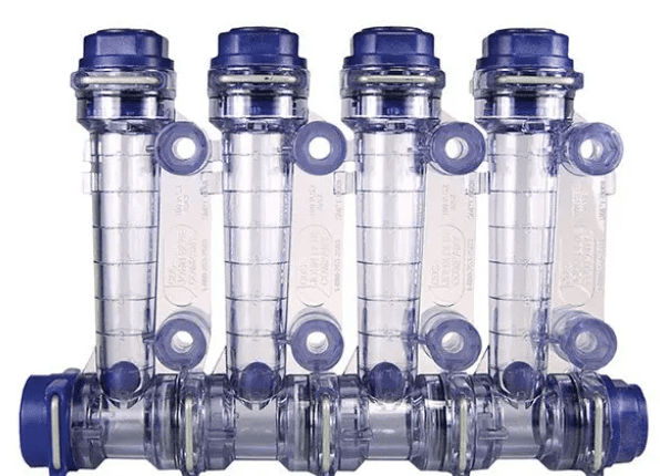 A group of six plastic bottles with blue lids.